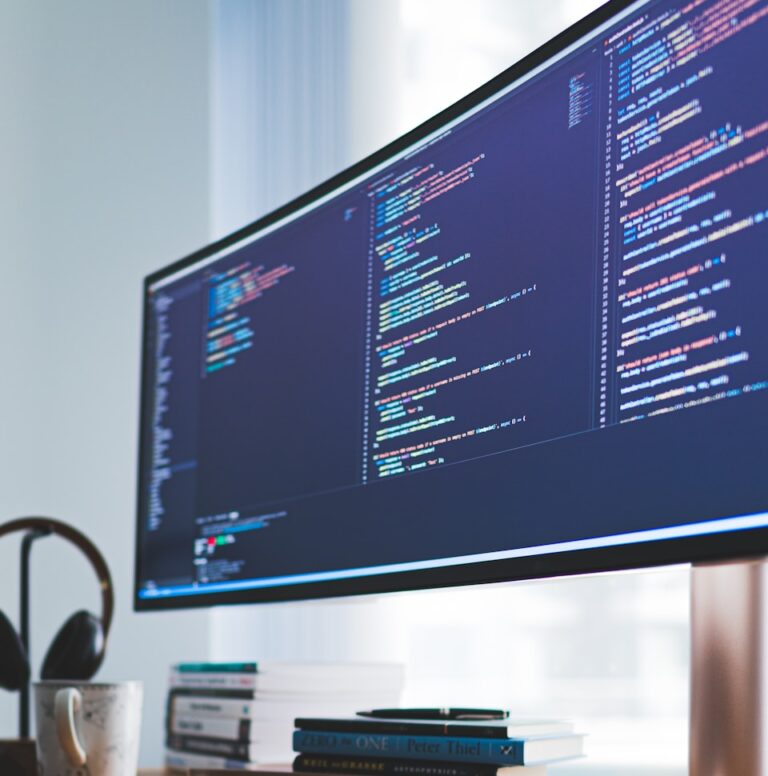 a computer monitor sitting on top of a wooden desk